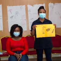 Women holding ArtTherapy sign