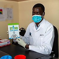 Kenya man holding a smoking cessation kit