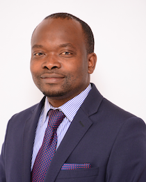 A person wearing a suit and purple tie.