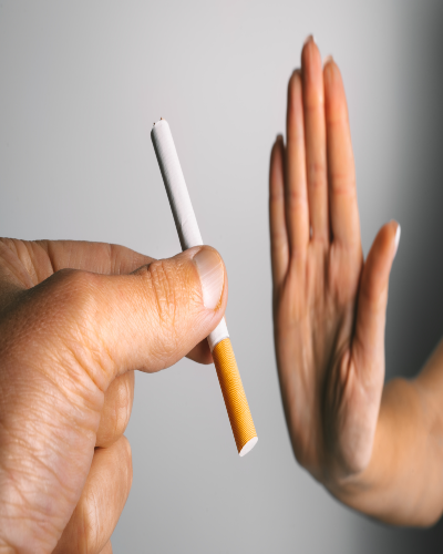 A hand rejecting the offering of a cigarette