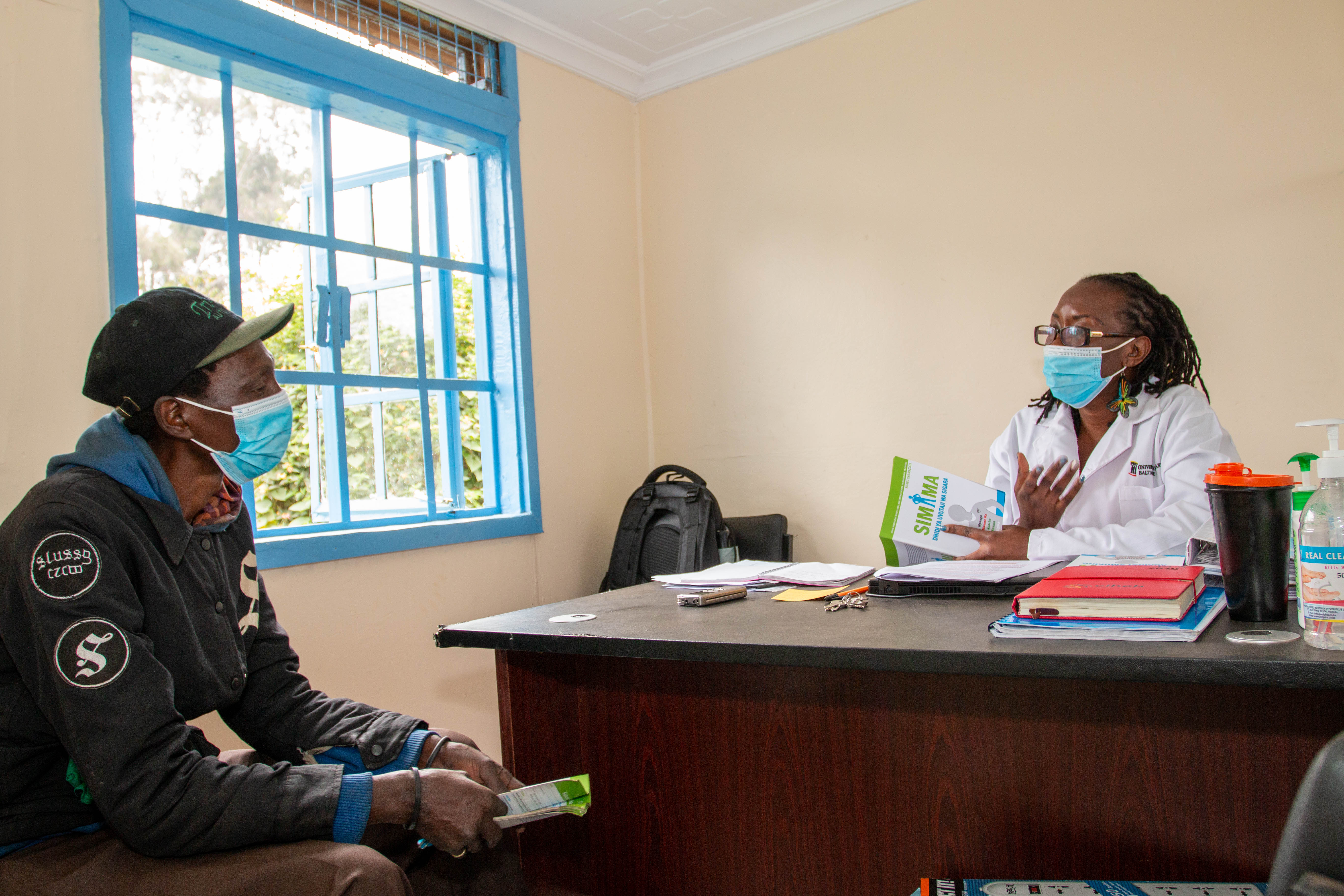 Maureen Ondire, a research assistant for the Smoking Cessation Study, takes a participant through PSF.