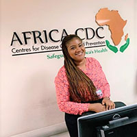 Woman in front of Africa CDC wall