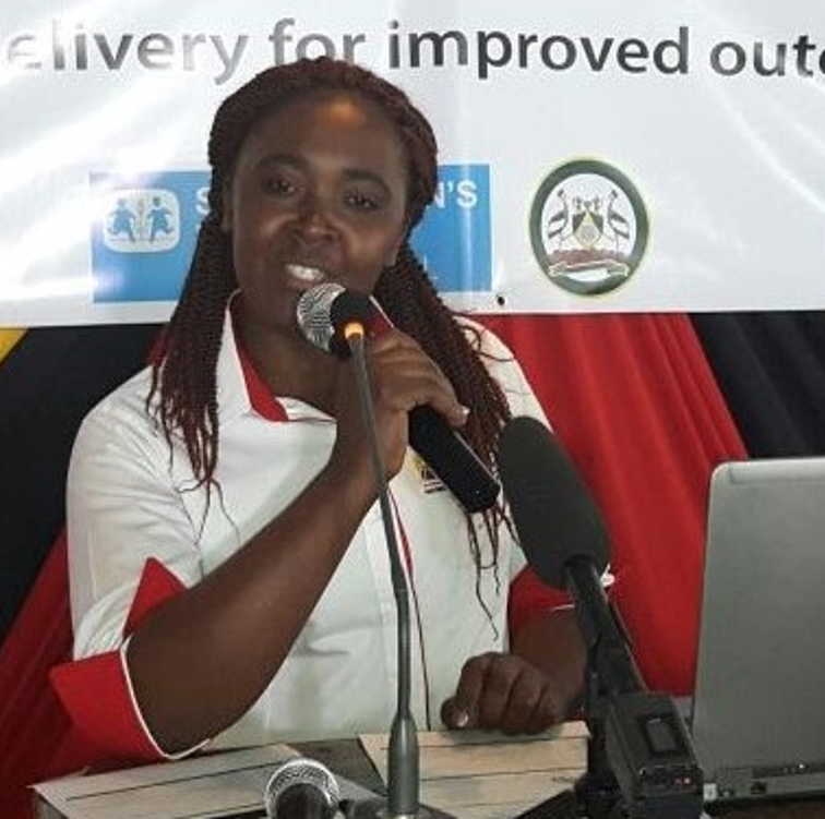 Photo of a woman speaking into a microphone