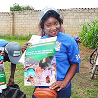 Zamphia worker holding a sign