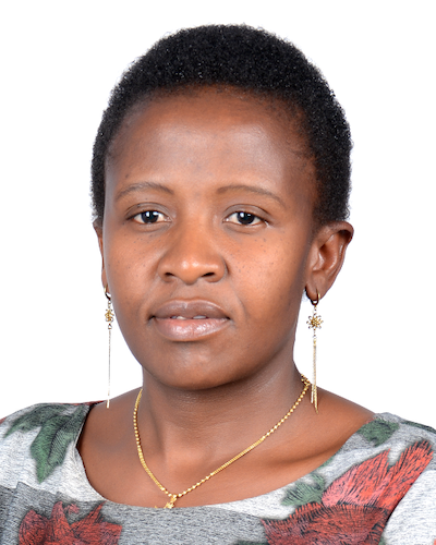 A woman with long ear rings poses for a photo.