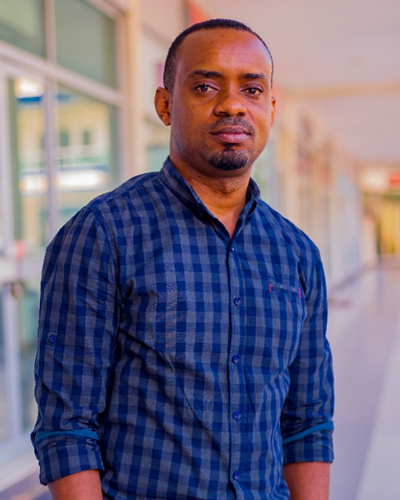 A man wears a dark blue button down shirt.