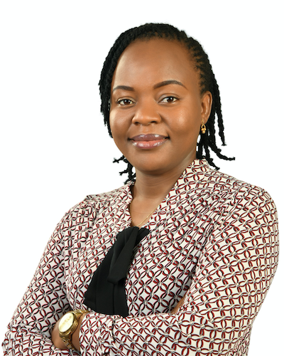 A woman wears a black blouse and a brown and white suit jacket.