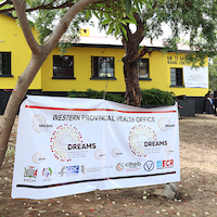 Thumbnail image of a banner in front of a yellow building.